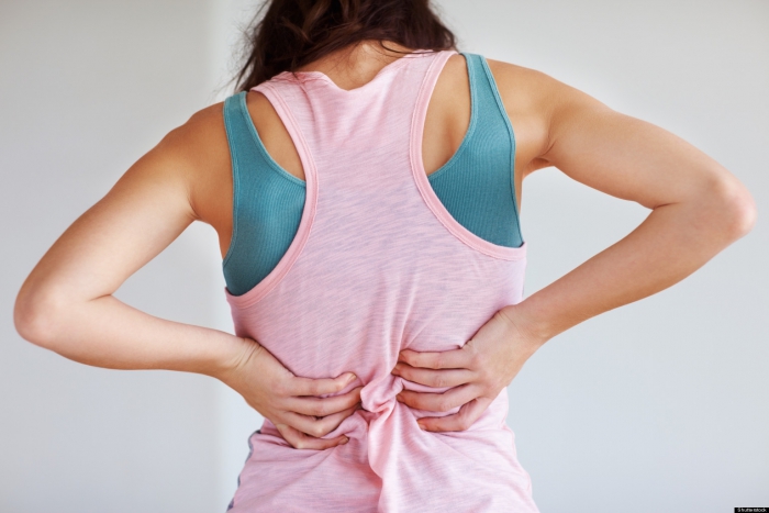 Woman holding her back